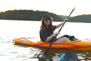 A candid memory of a kayaking girl who wears Noz at sunset. The active paddling posture alludes to Noz advertising to sporting consumers.